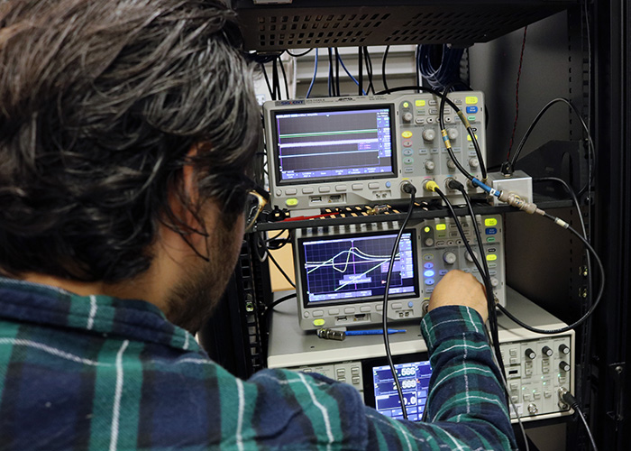 Student looks at readings on a quantum optics device