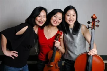 Three women with two holding string instruments