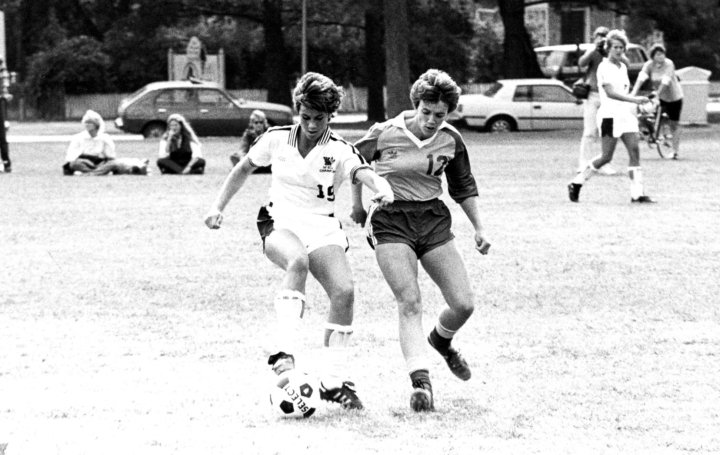 Two people play soccer.