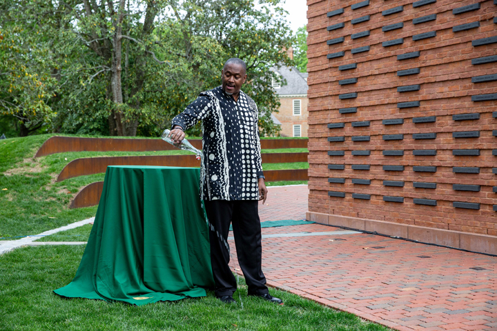 Steve Prince pours water from a bottle