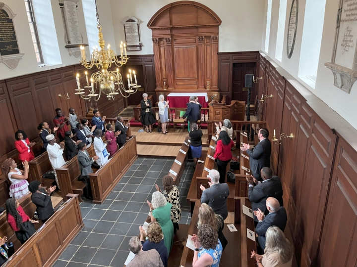 People giving a standing ovation in the Wren Building Chapel.