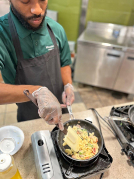 A person cooks on a skillet