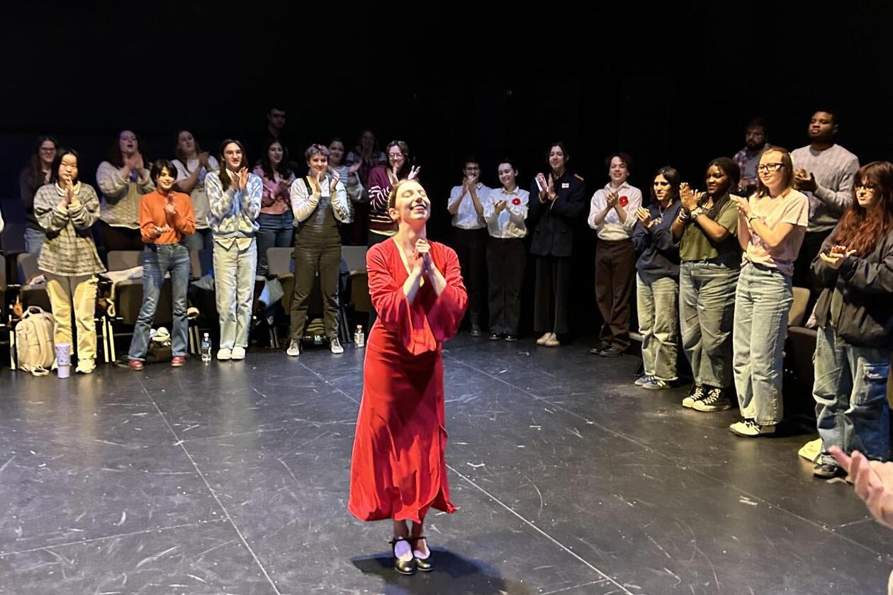 This is a photo of Cate Oken '27 performing in William & Mary's Shakespeare in the Dark performance of Macbeth in Phi Beta Kappa Memorial Hall.