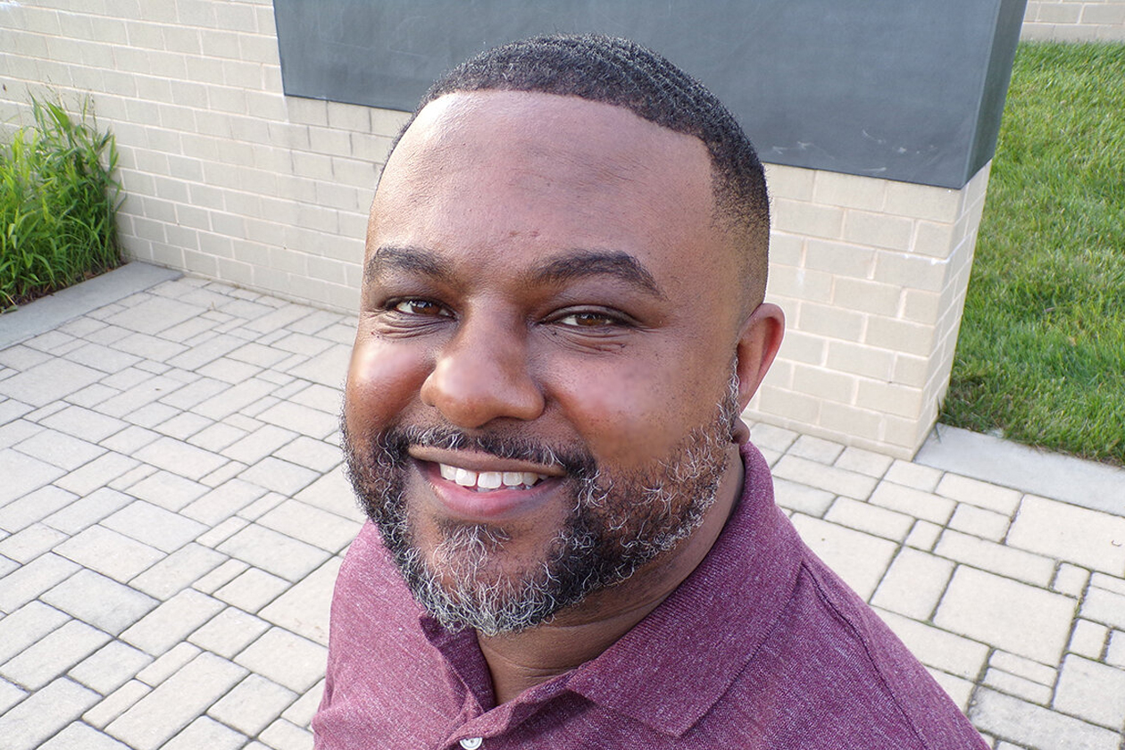 Lamar Giles smiles for a photo.