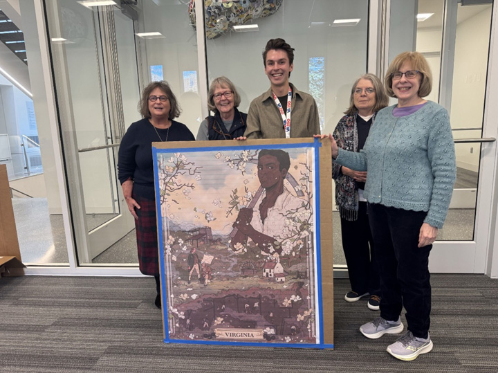 Five people stand with a large image on cardboard.