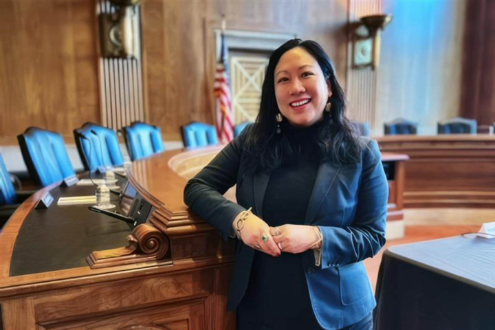 Margaret Hu stands in a courtroom.