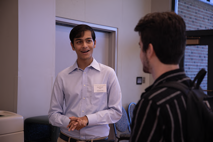 Two young men speaking with each other