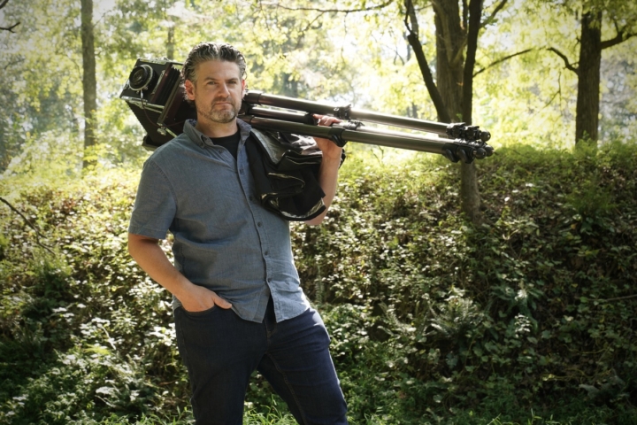 Professor of Photography poses with his large view camera for a story about 20 of his photographs being acquired by the Library of Congress