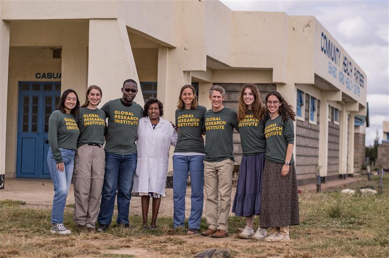 Picture of researchers standing outside of a clinic in Kenya.