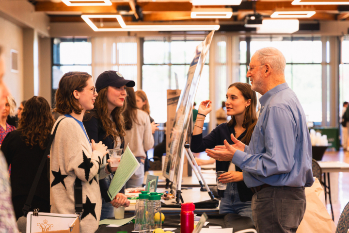 Students and faculty discuss research opportunities at a fair to highlight all the interesting topics under study on campus
