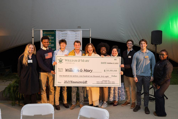 People pose for a photo with a giant check made out to William & Mary for more than $101,000.