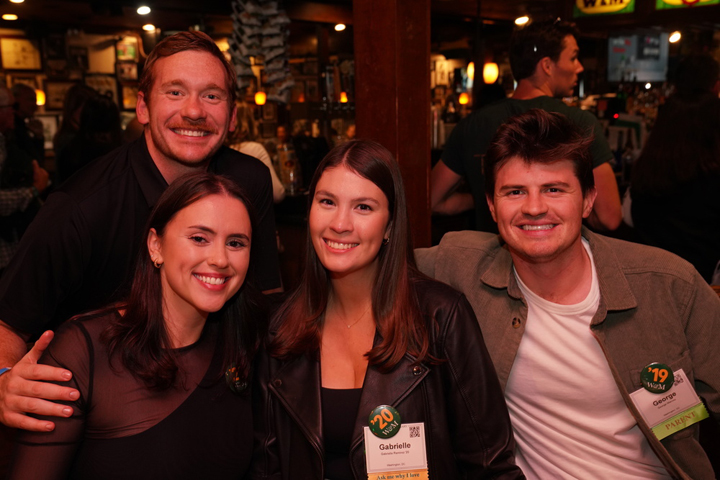 Four people pose for a photo together.