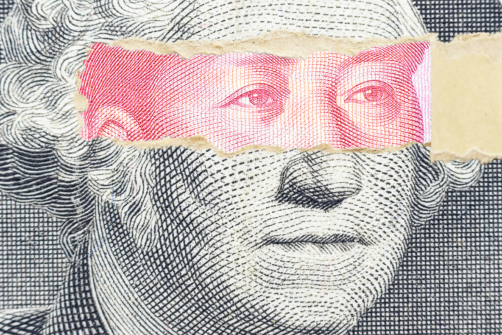 A graphic shows a piece of a dollar bill torn open at over the the eyes of George Washington, revealing other eyes underneath.