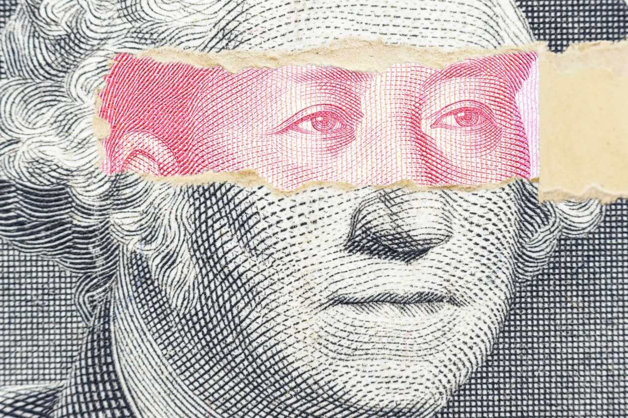 A graphic shows a piece of a dollar bill torn open at over the the eyes of George Washington, revealing other eyes underneath.