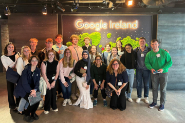 People gather for a photo by a sign that says Google Ireland.