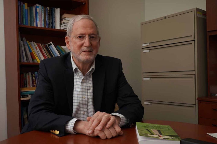 Photo of professor at a table