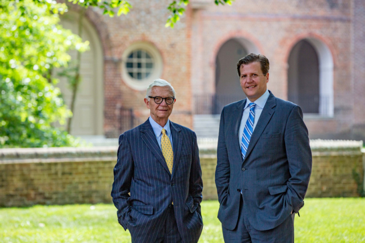 Two Taylor Reveleys pose for a photo together while standing outside of the Wren Building.