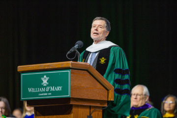 Ken Burns speaks while standing at a podium.