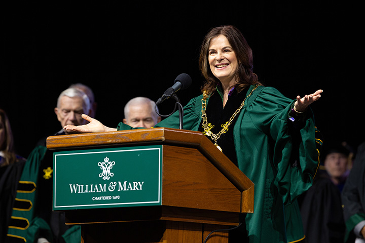 Katherine Rowe gestures while standing at a podium.