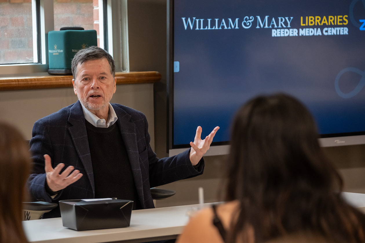 Photo of man speaking in front of students