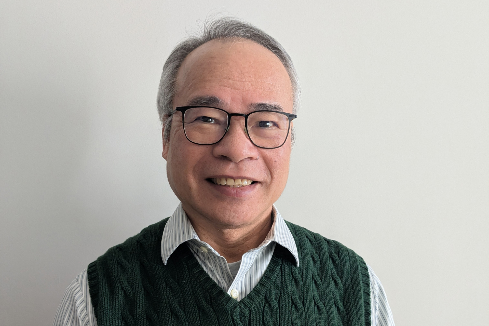 Photo of a man on a coach next to a plant