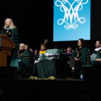 A person speaks while standing at a podium.