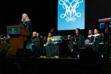 A person speaks while standing at a podium.
