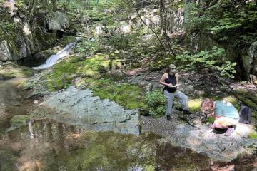 Photo of two people in the woods.