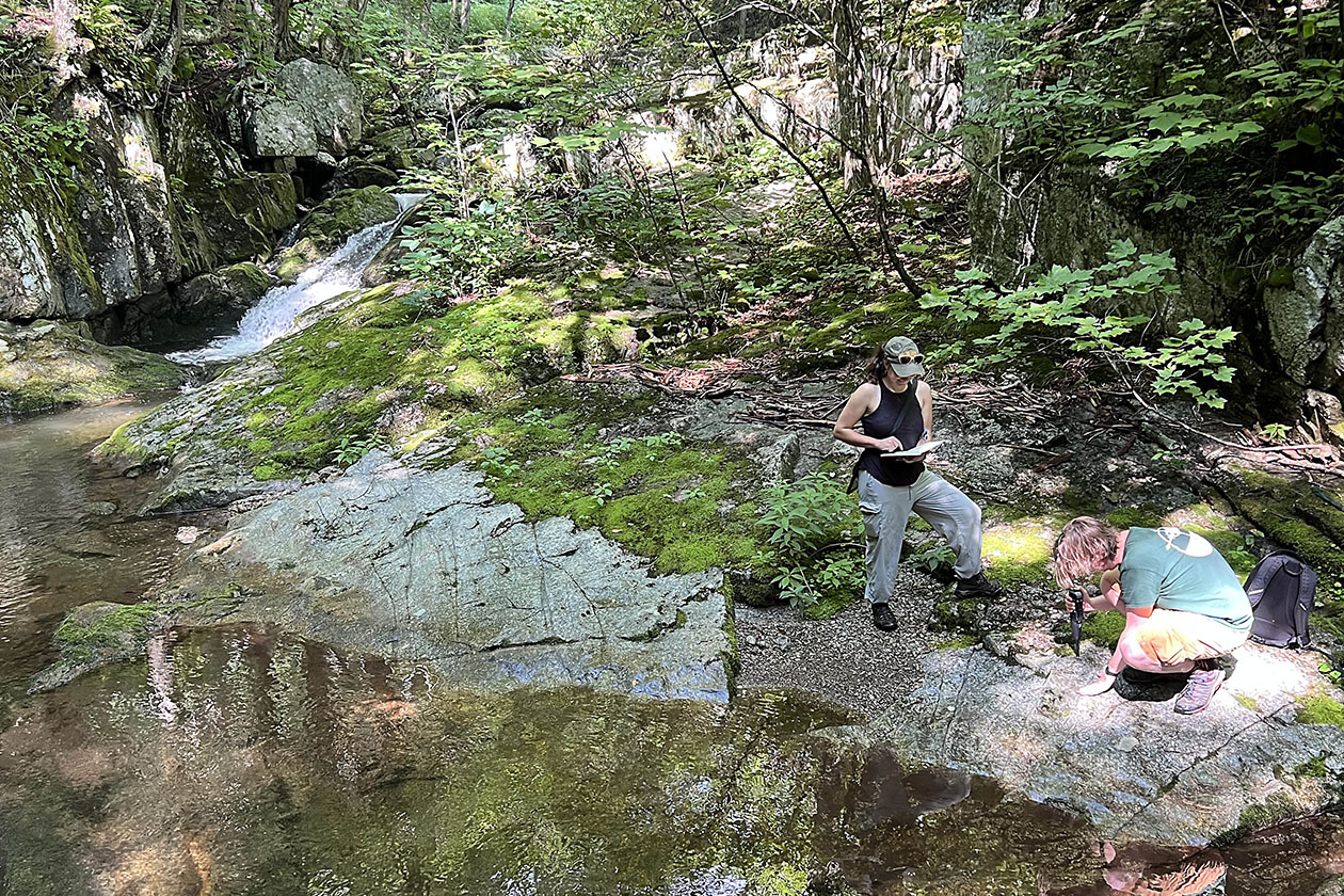 Photo of two people in the woods.