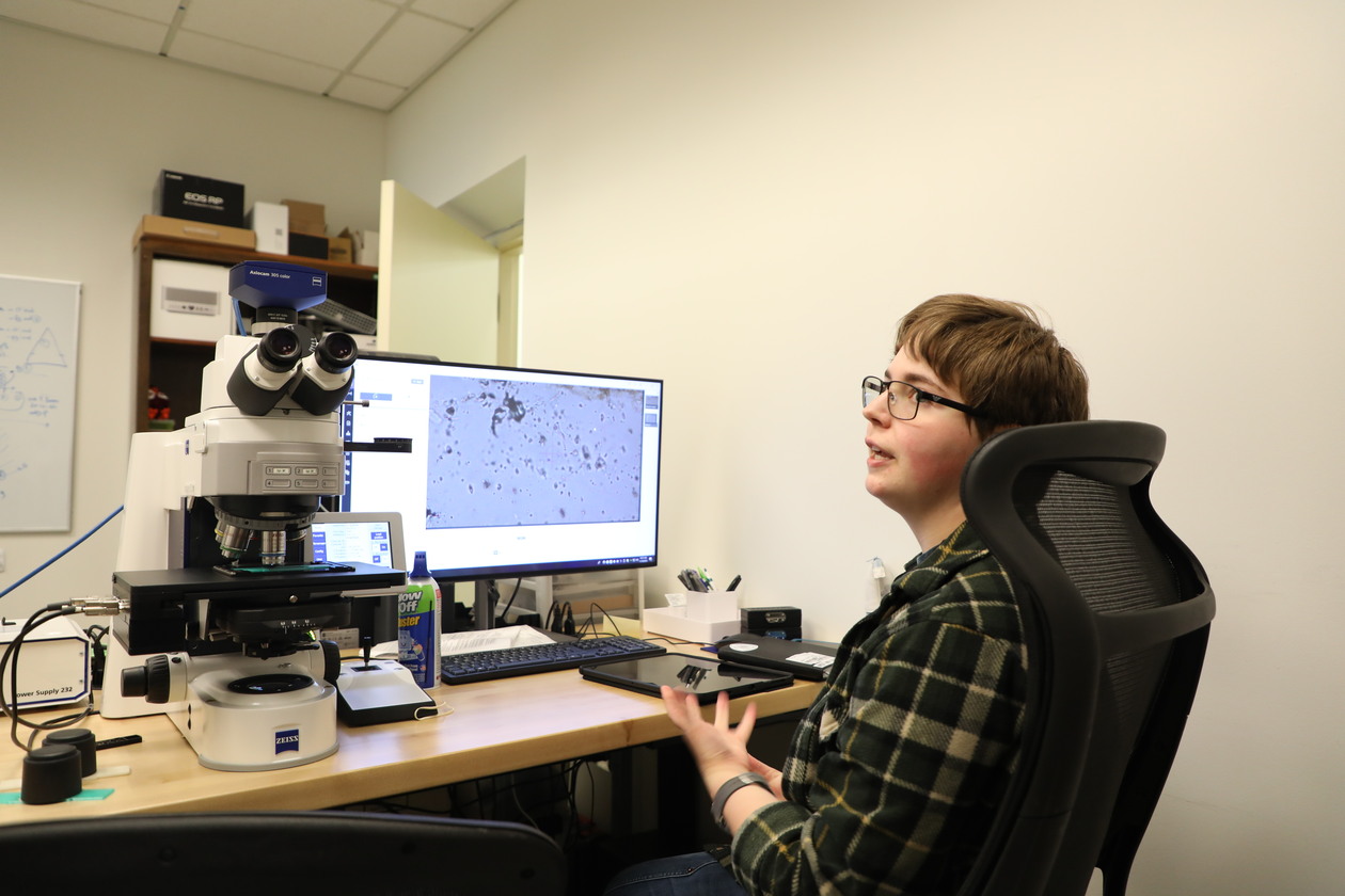 This is a photo of WM student Marina Ashurkoff '26, a geology and English double major, examining quartz crystals found on burial grounds of the enslaved at James Madison's Montpelier.