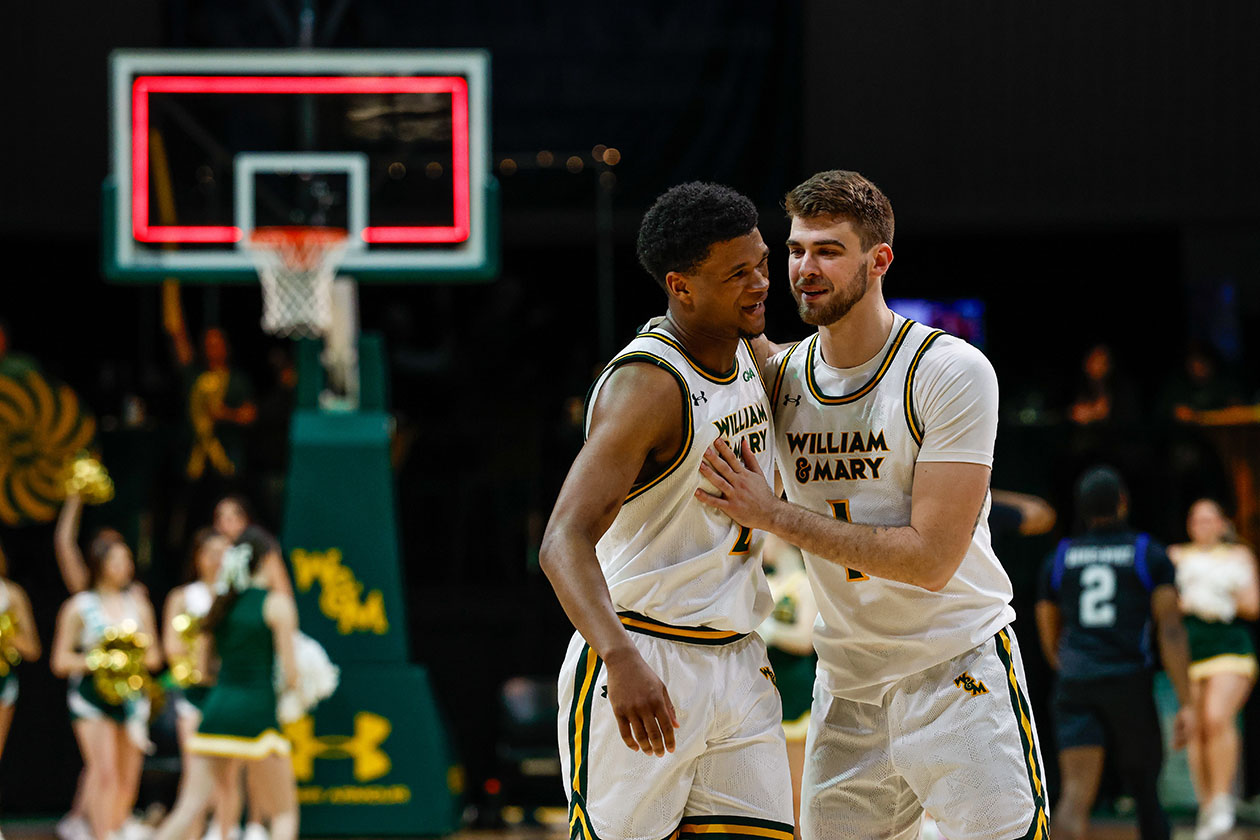Two basketball players talk on the court.
