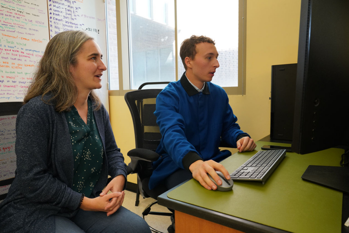 Photo of two people in front of a computer.