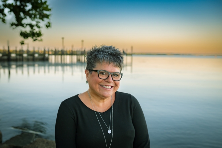 Amy Rosenkrans stands next to a body of water and pier.