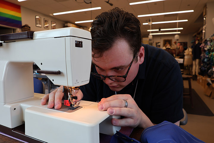 A person works on a sewing machine.