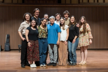 This is a photo of the cast of Godspell with the man who wrote its music, composer Stephen Schwartz