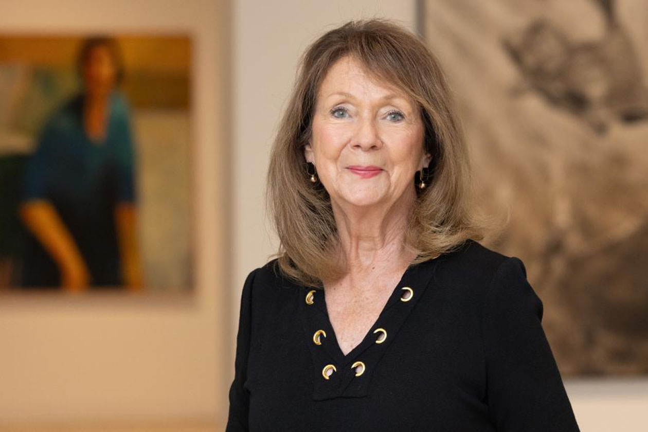 Judi Starkey stands in a museum gallery.