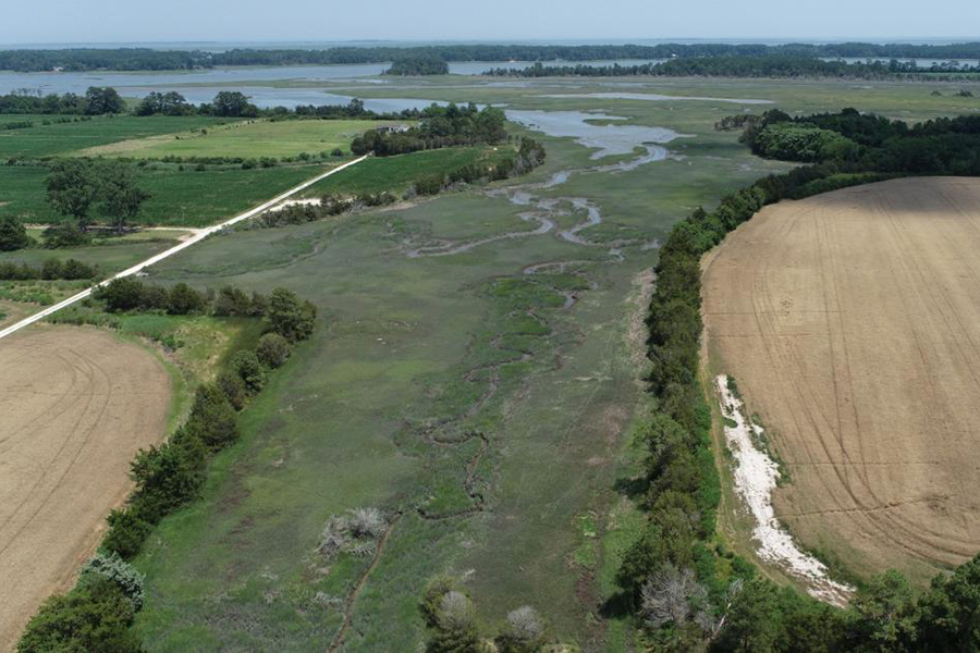 An aerial view of fields shows encroaching waters.