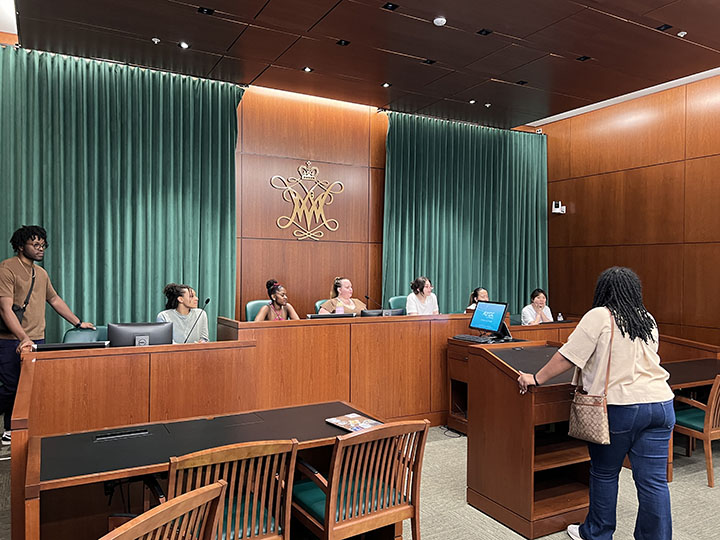 People sit in a mock courtroom.