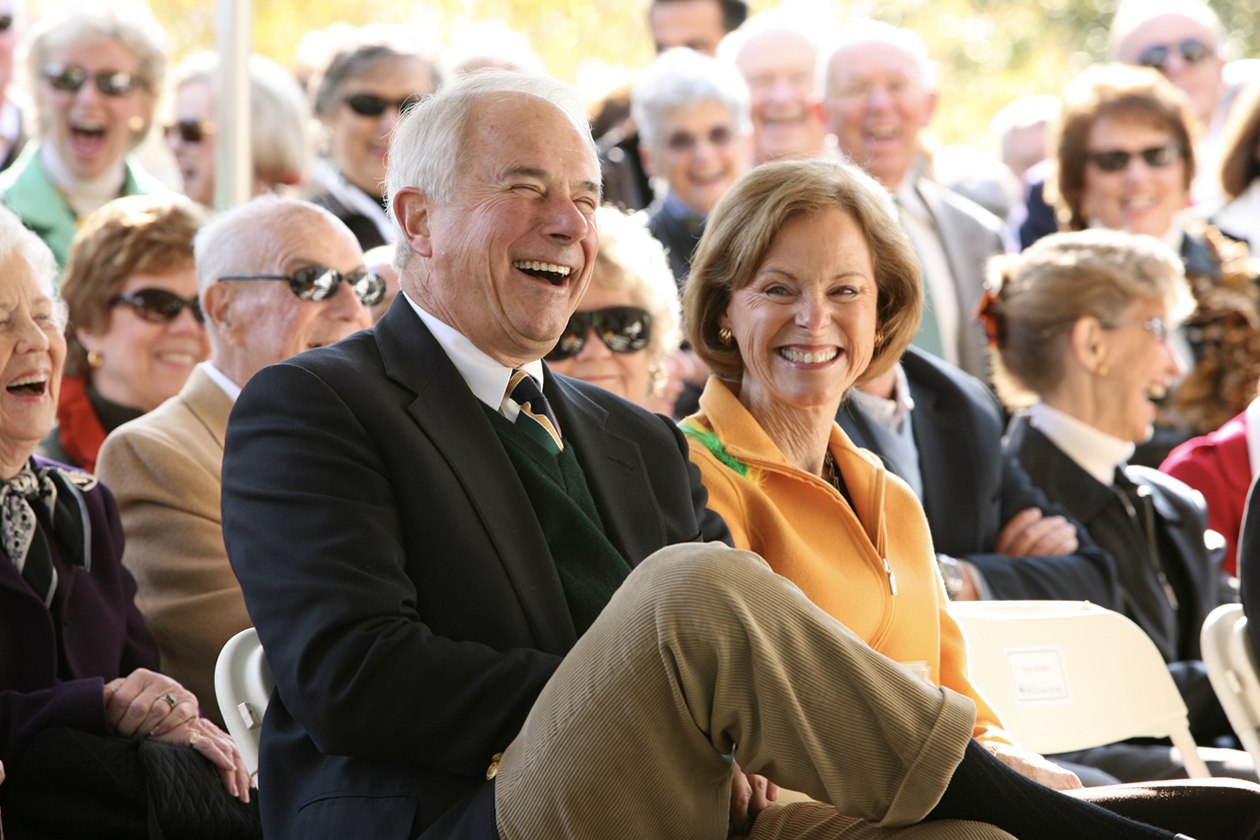 Jim Ukrop laughs while standing in a crowd.