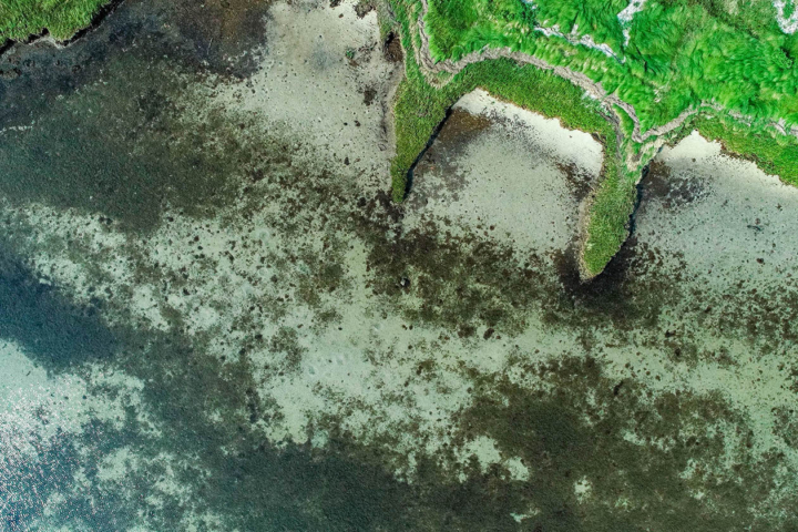 An aerial view shows a coastline.
