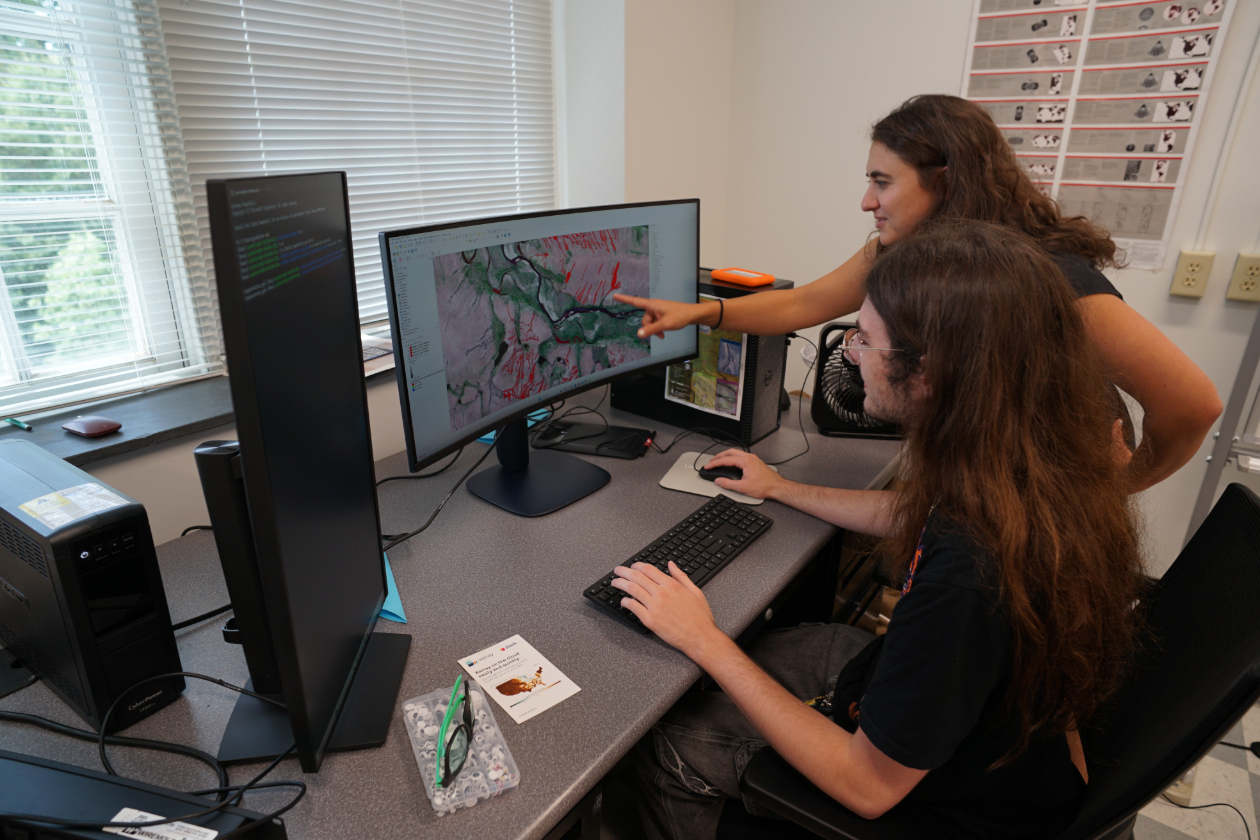 This is a photo of Gabriel Imholte ‘28 conducting his geology research on campus alongside his research advisor Joanmarie Del Vecchio. through the Summer Research Scholars program.