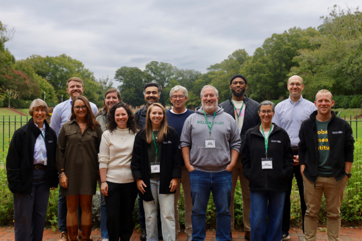 A group of people take a photo together in an outdoor location.