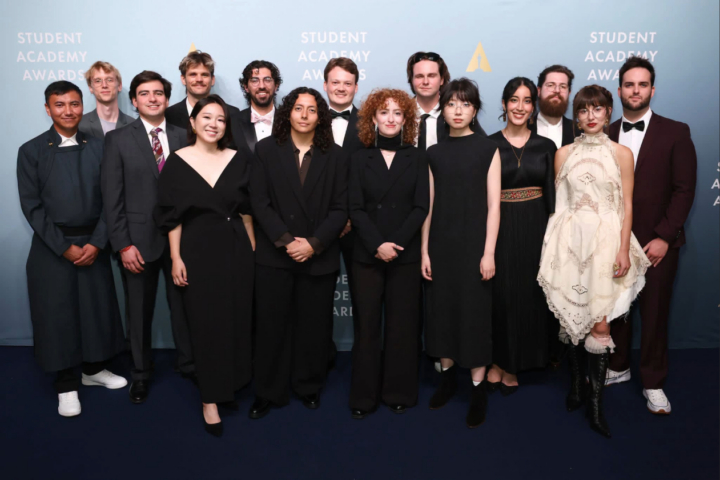This is a photo of Arjun Fisher '20 with the 14 other 2026 Student Academy Award winners on the award ceremony red carpet.