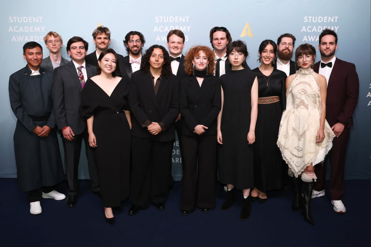This is a photo of Arjun Fisher '20 with the 14 other 2026 Student Academy Award winners on the award ceremony red carpet.
