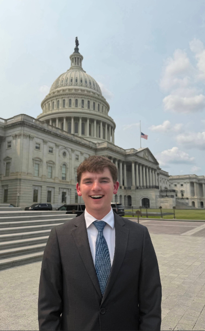 This is a photo of Nate Acklie '29, standing in front of the U.S. Capitol where we worked as an intern