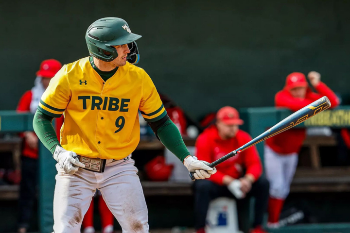 A baseball player swings a bat.
