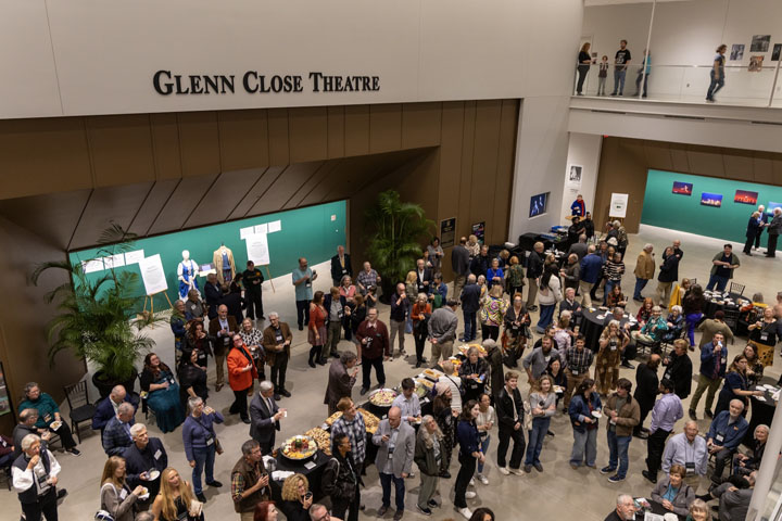 People gather in the lobby of a theater.