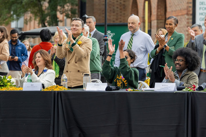 People clap their hands and cheer.
