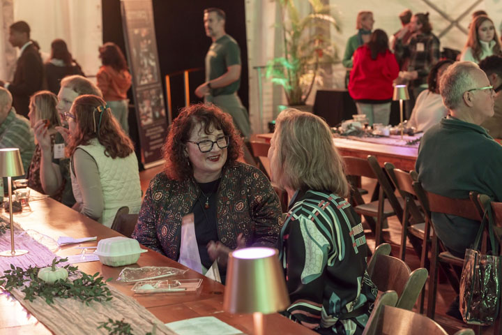 People chat over a meal.